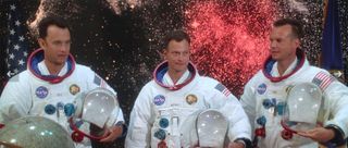 three astronauts in their suits next do an image of stars in the sky in apollo 13