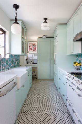 A kitchen with mint green interiors