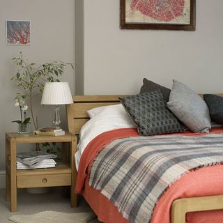 bedroom with red duvet and bedside table in victorian terrace in bristol