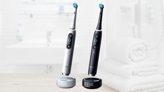 Oral-B iO Series 10 electric toothbrushes in white and black