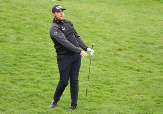 Dan Bradbury hits a wedge out of the rough