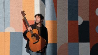 Scott Metzger holds his 1955 Martin 000-18 acoustic guitar