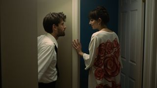 (L to R) Cooper Raiff as Andrew, sharing a look with Dakota Johnson as Domino, in Cha Cha Real Smooth, as she's about to enter a room