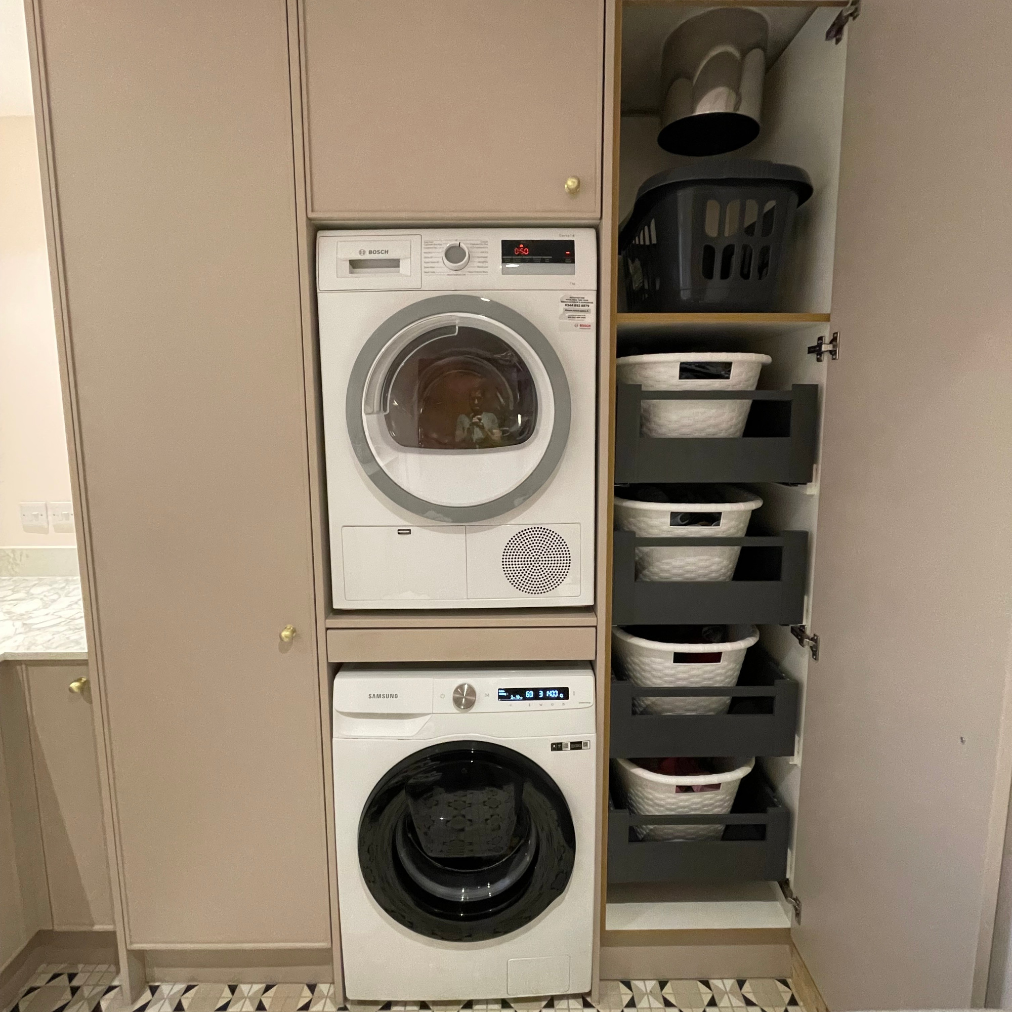 utility room with laundry chute, drawers with baskets and washing machine and dryer