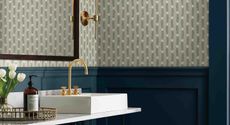 blue wallpapered bathroom with countertop basin