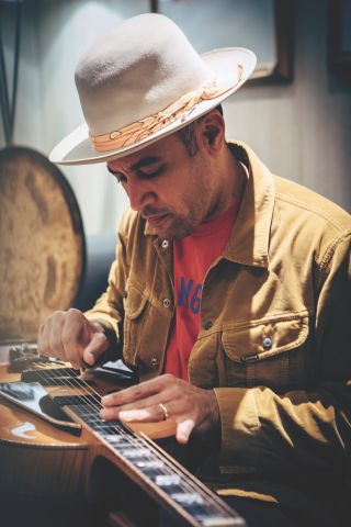 Ben Harper plays a lap steel guitar