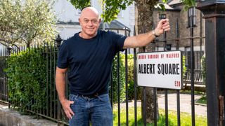 Ross kemp standing next to an Albert Square sign on the EastEnders set