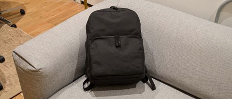 A Lo & Sons Hanover Deluxe 2 backpack on a gray couch