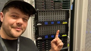 Tom's Guide VPN Editor Mo Harber-Lamond in front of an active VPN server rack