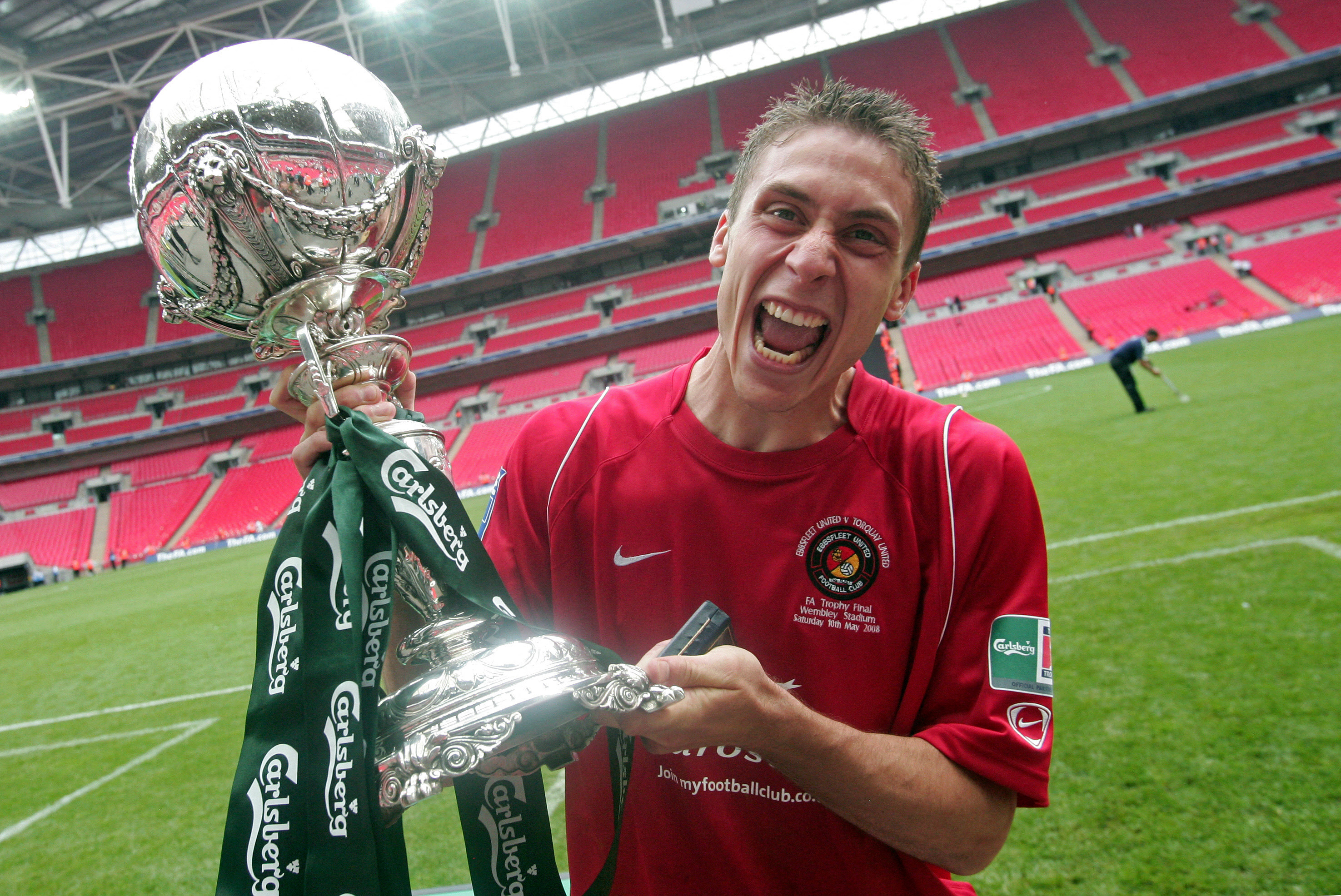 Ebbsfleet United's Chris McPhee celebrates with the FA trophy after his winning goal secured their victory in the FA Trophy Final at Wembley football Stadium, in London on May 10, 2008. Ebbsfleet won the match 1-0. AFP PHOTO/CARL DE SOUZA
Mobile and website use of domestic English football pictures are subject to obtaining a Photographic End User Licence from Football DataCo Ltd Tel : +44 (0) 207 864 9121 or e-mail accreditations@football-dataco.com - applies to Premier and Football League matches. (Photo by CARL DE SOUZA / AFP)