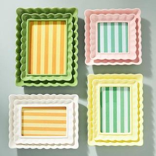 Four colorful, scalloped picture frames from Anthropologie
