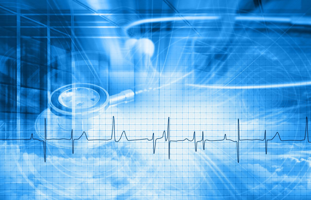 abstract image of heart monitor with stethoscope in the background