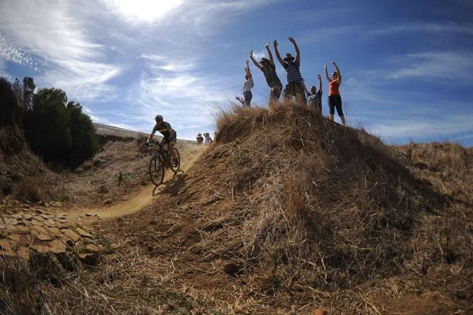 Spectators cheer on riders