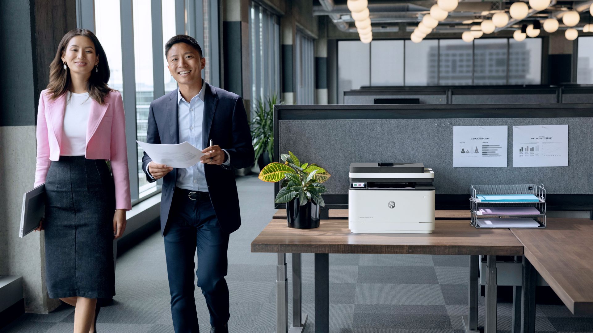 Two people working next to the HP LaserJet Pro 3101sdw