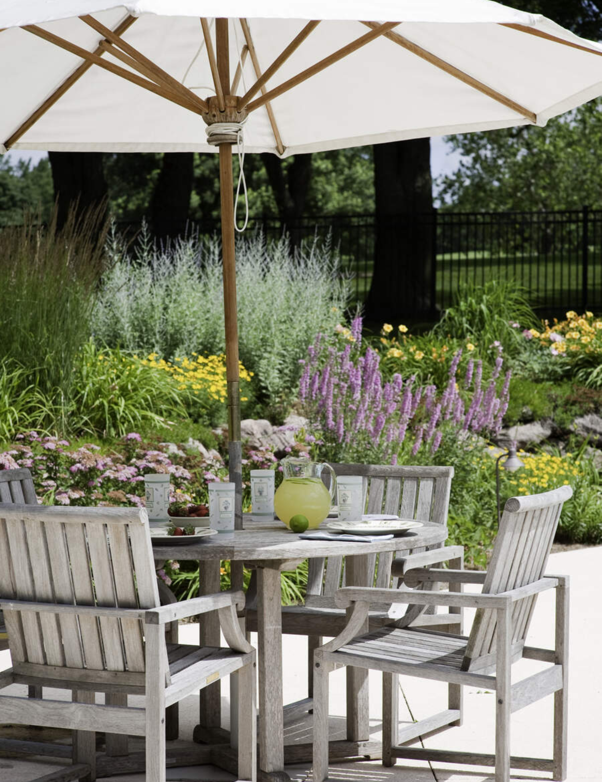 Charming patio dining set styled with a white parasol for shade