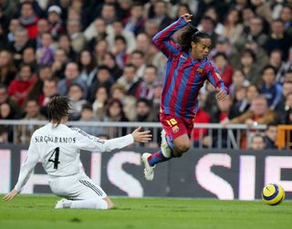 Ronaldinho (R) of Barcelona gets past Sergio Ramos of Real Madrid during a Primera Liga match between Real Madrid and F.C. Barcelona at the Bernabeu on November 19, 2005 in Madrid, Spain.