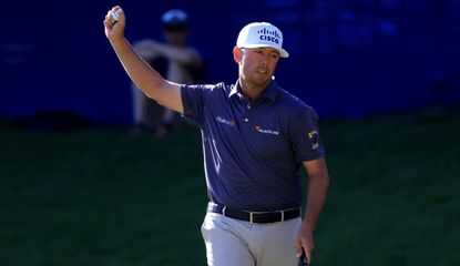 Reavie waves his hand after holing the winning putt