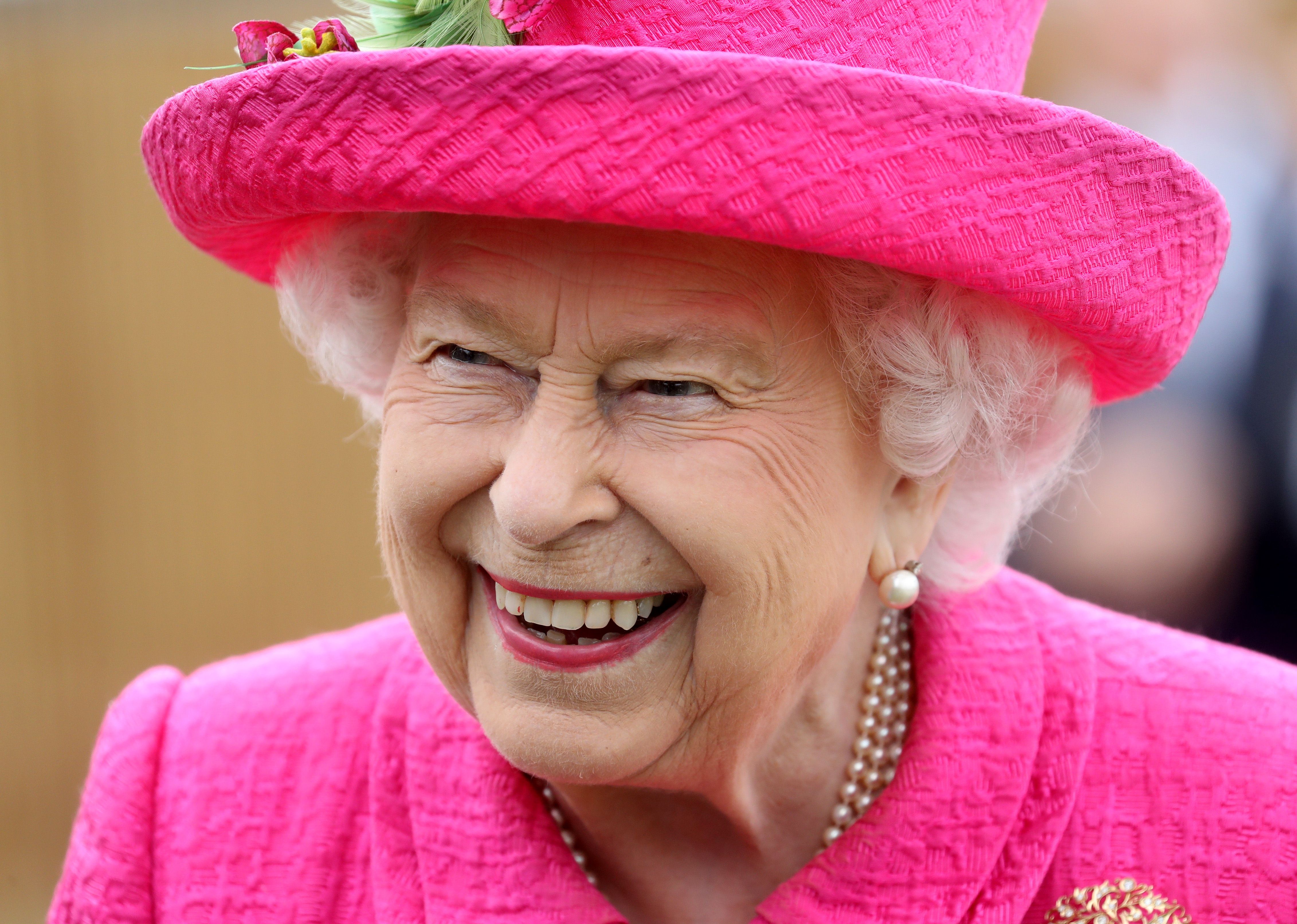 The hat may be pink but the fingers are green: HM The Queen at NIAB on July 9.