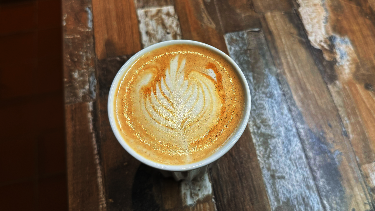 a photo of a latte made on the breville bambino / sage bambino