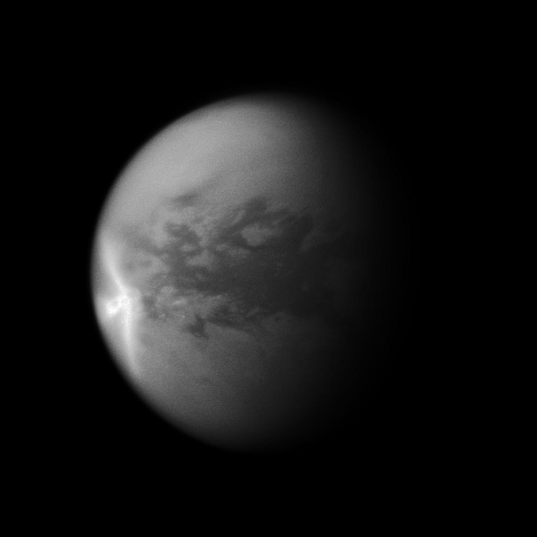 A huge arrow-shaped storm blows across the equatorial region of Saturn&#039;s Moon Titan.