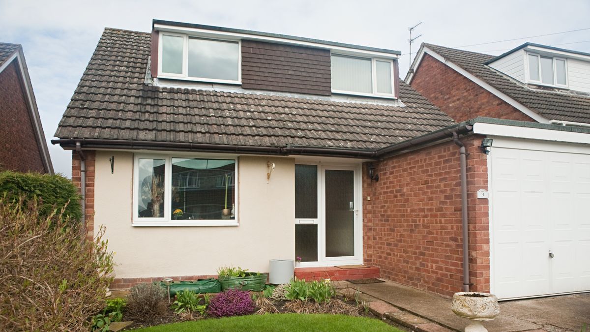 dormer bungalow with flat roofed garage attached