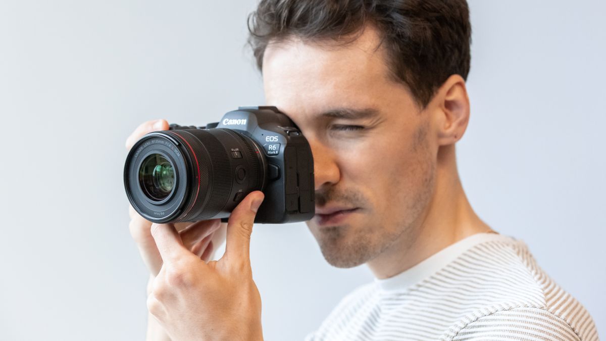 Canon RF 35mm f/1.4L VCM lens attached to a Canon EOS R6 Mark II camera held up to person&#039;s face