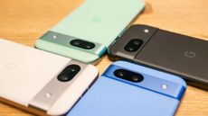 Google Pixel 8a in all four colors positioned next to each other on table.