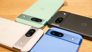 Google Pixel 8a in all four colors positioned next to each other on table.