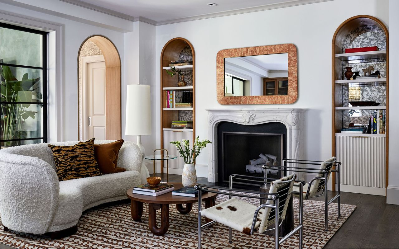 living room with grey walls, boucle sofa, fireplace, large window