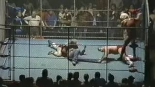 The Four Horsemen preparing to break Dusty Rhodes' leg