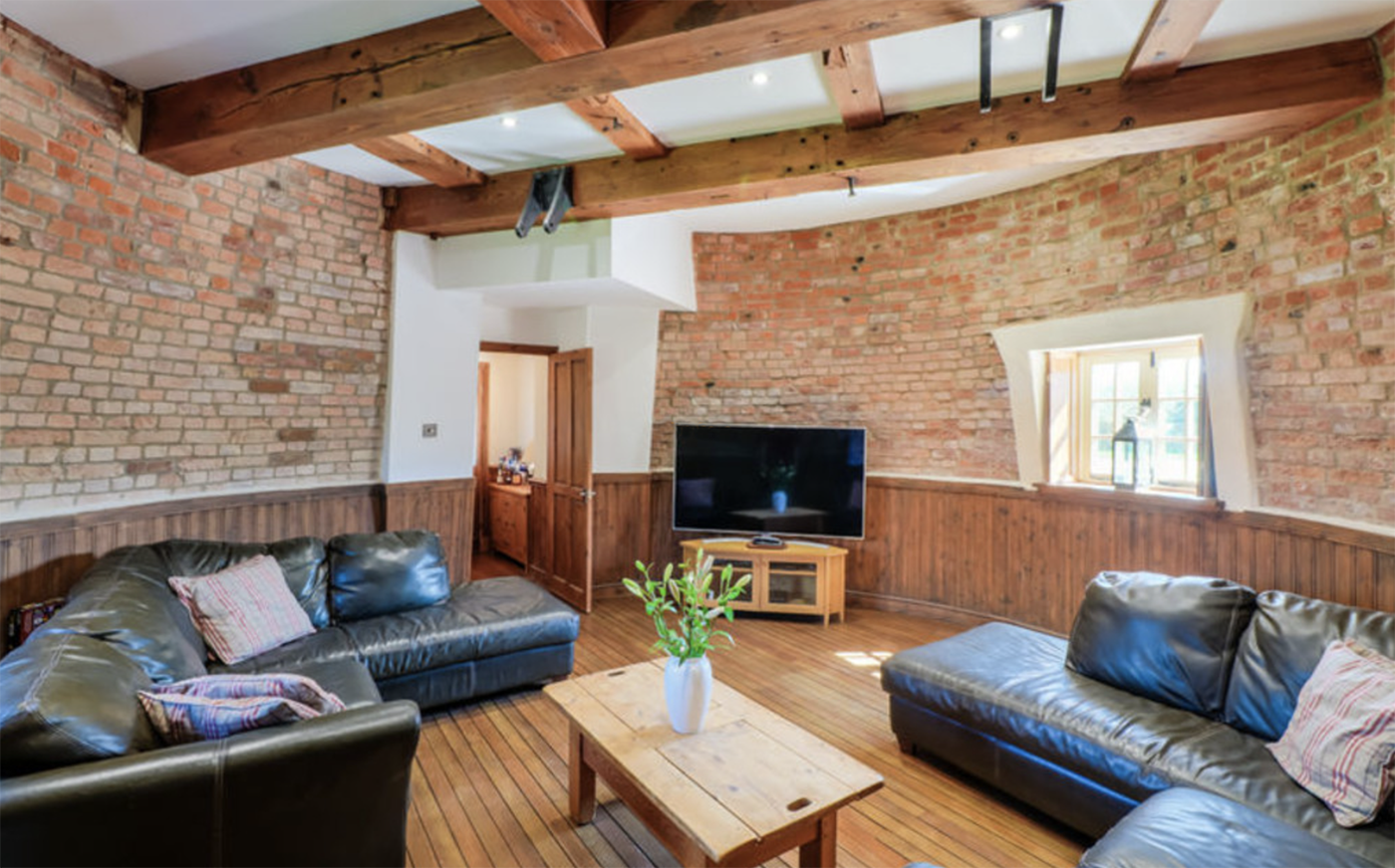 Circular sitting room with TV in converted mill, Lincs
