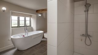 renovated bathroom with deep window reveal and exposed beams