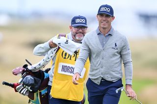 Billy Horschel walks up the fairway with his caddie