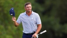Bryson DeChambeau acknowledges the crowd after his first round at the 2024 Masters