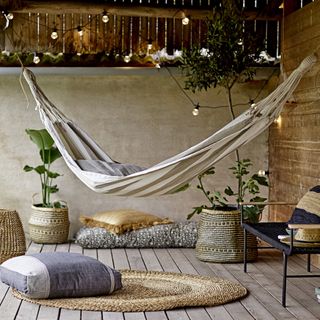 room with hammock and circular rug on floor