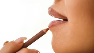 woman applying lip liner