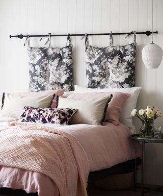An example of bed ideas showing a bed with a monochrome floral fabric headboard