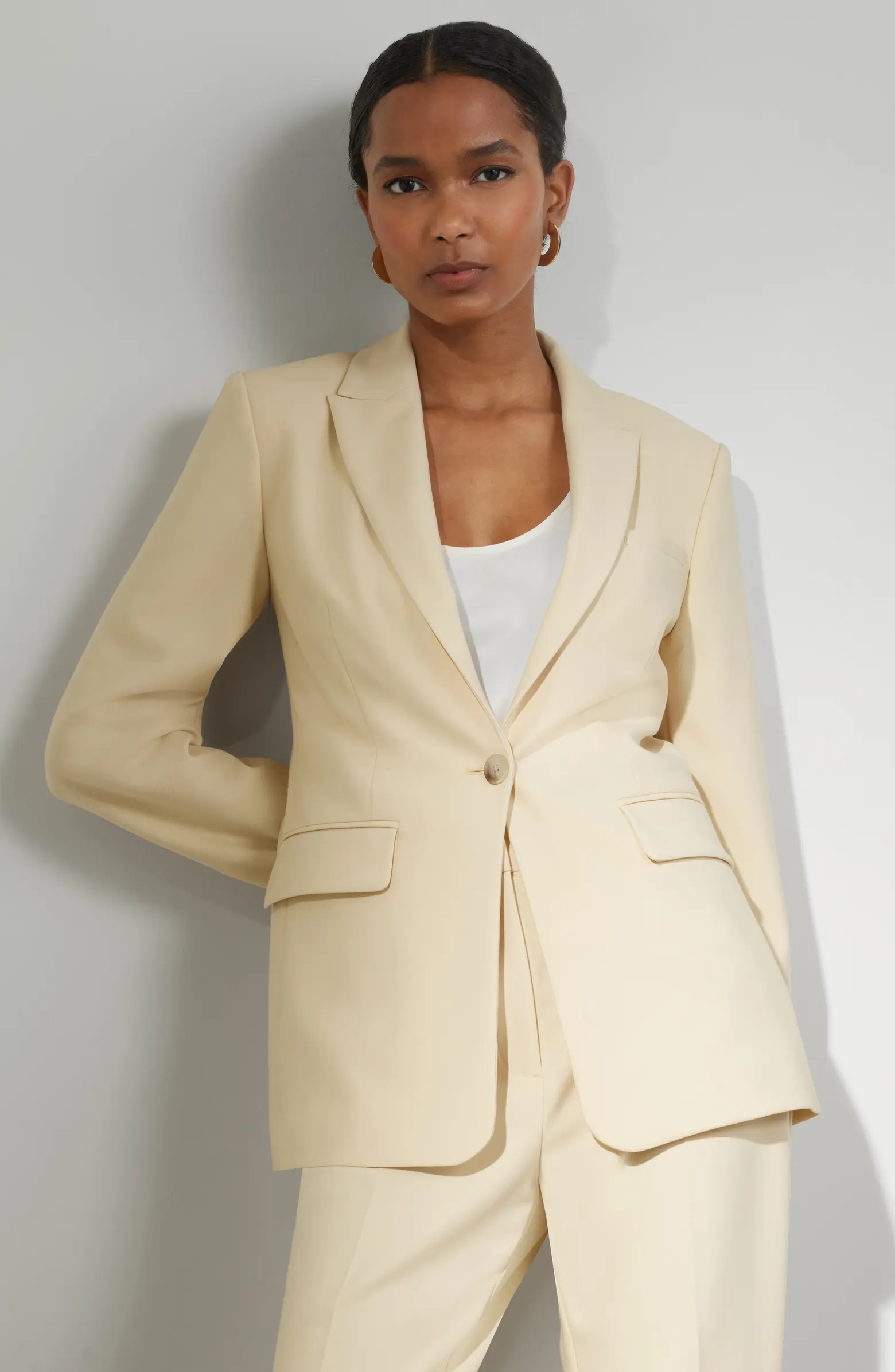 A model in a butter yellow suit