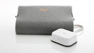 The Motion Pillow 3 in gray with a white control box placed next to it