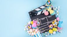 Cinema clapper-board with Easter chocolate egg. popcorn and marshmallow