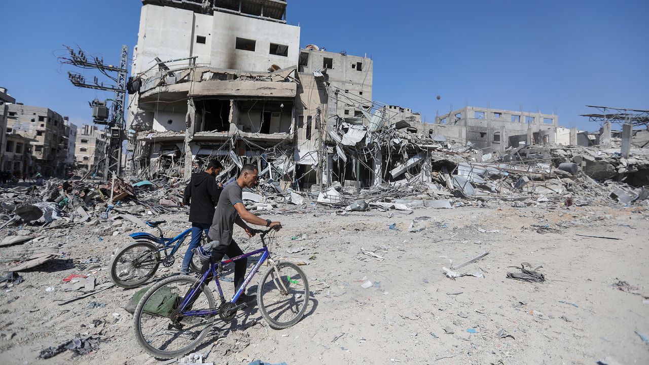 People inspect damage following Israeli airstrikes in Khan Yunis, Gaza