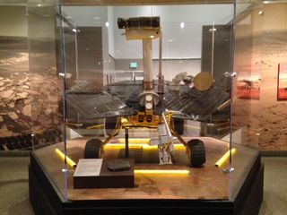 A model of the twin Mars Exploration Rovers named Spirit and Opportunity stands in a gallery honoring the Red Planet robots.