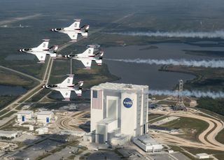 The USAF Thunderbirds flew over the Vehicle Assembly Building at the Kennedy Space Center in Florida April 2, 2017. The Apollo 11 Saturn V rocket was assembled inside the building. Apollo 11 astronaut Buzz Aldrin joined the team for a demonstration flight.