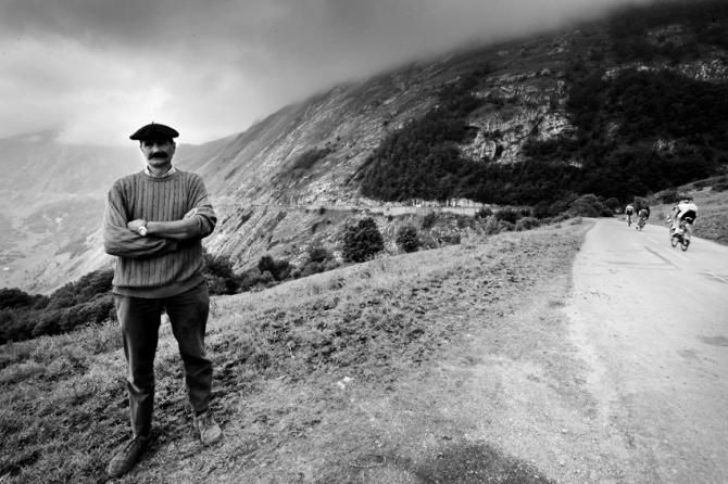 A B&eacute;arnaise farmer is fairly disinterested in the cyclists, posing for his portrait as the peloton rides over the Col d'Aubisque on their way to the Col du Soulor