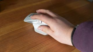 Logitech MX Master 3S mouse held in reviewer's hand