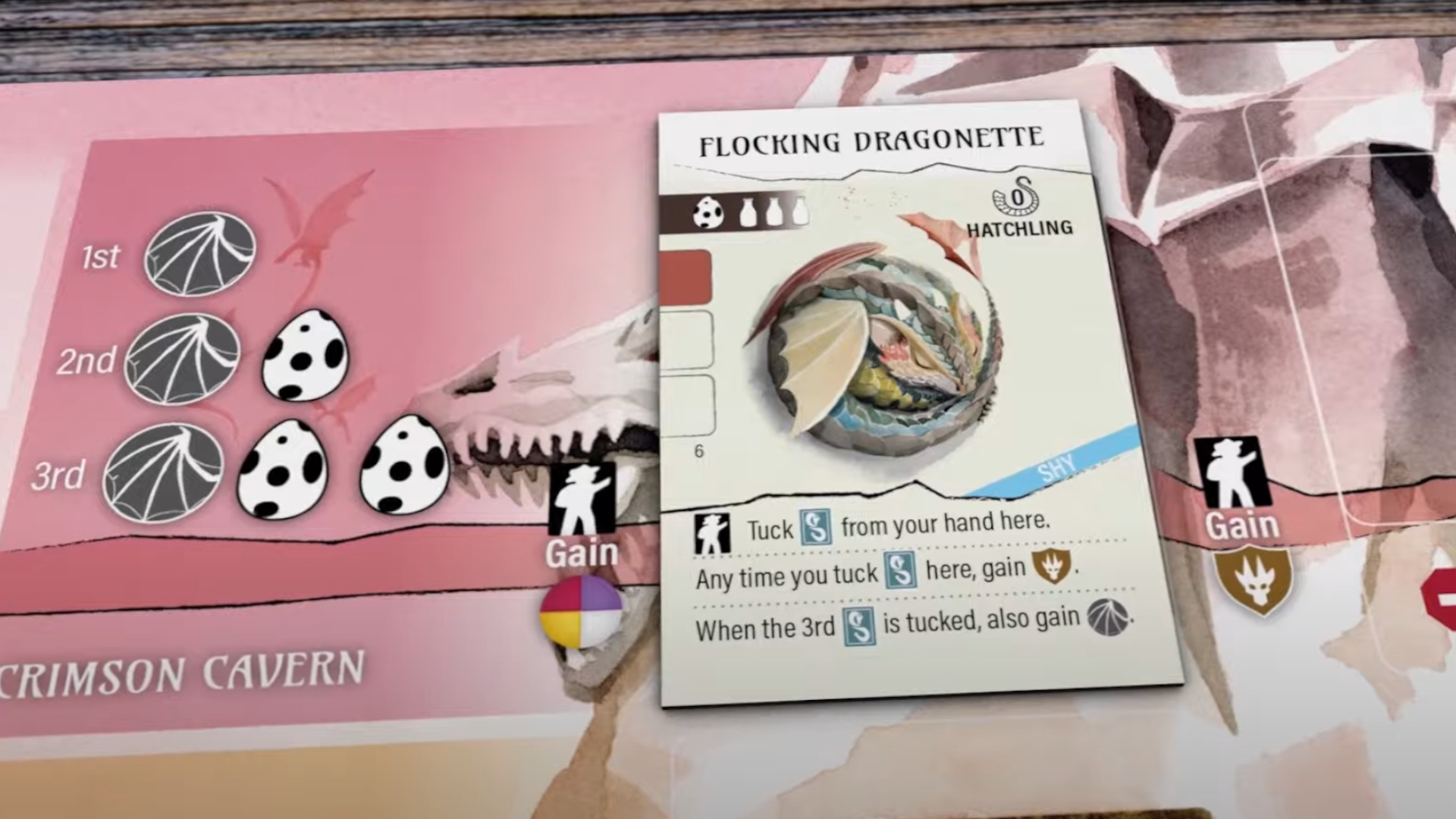 A Hatchling card sits on a board from Wyrmspan