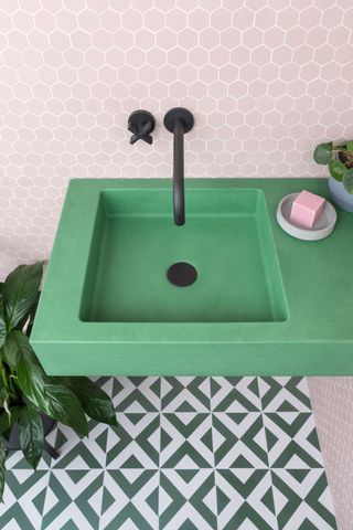 Bright green concrete sink with patterned floor