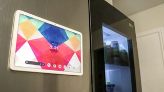 The Google Pixel Tablet magnetically attached to an LG refrigerator