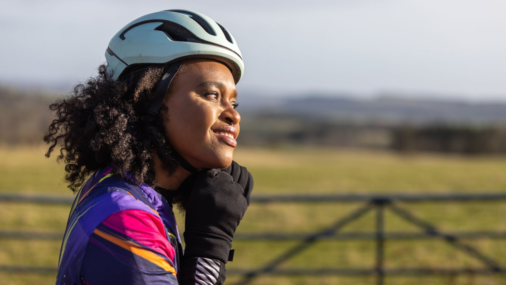 Woman tightening bike helmet