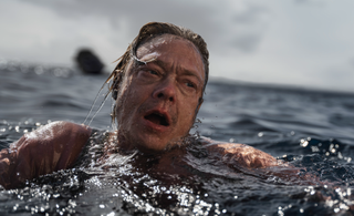 Kristoffer Joner as Alfred, swimming in the sea